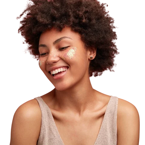 Smiling woman with smooth skin and subtle glitter on her cheeks